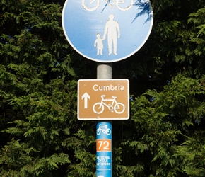 Cumbria Cycleway Sign on the A689. There are 3 of them close together